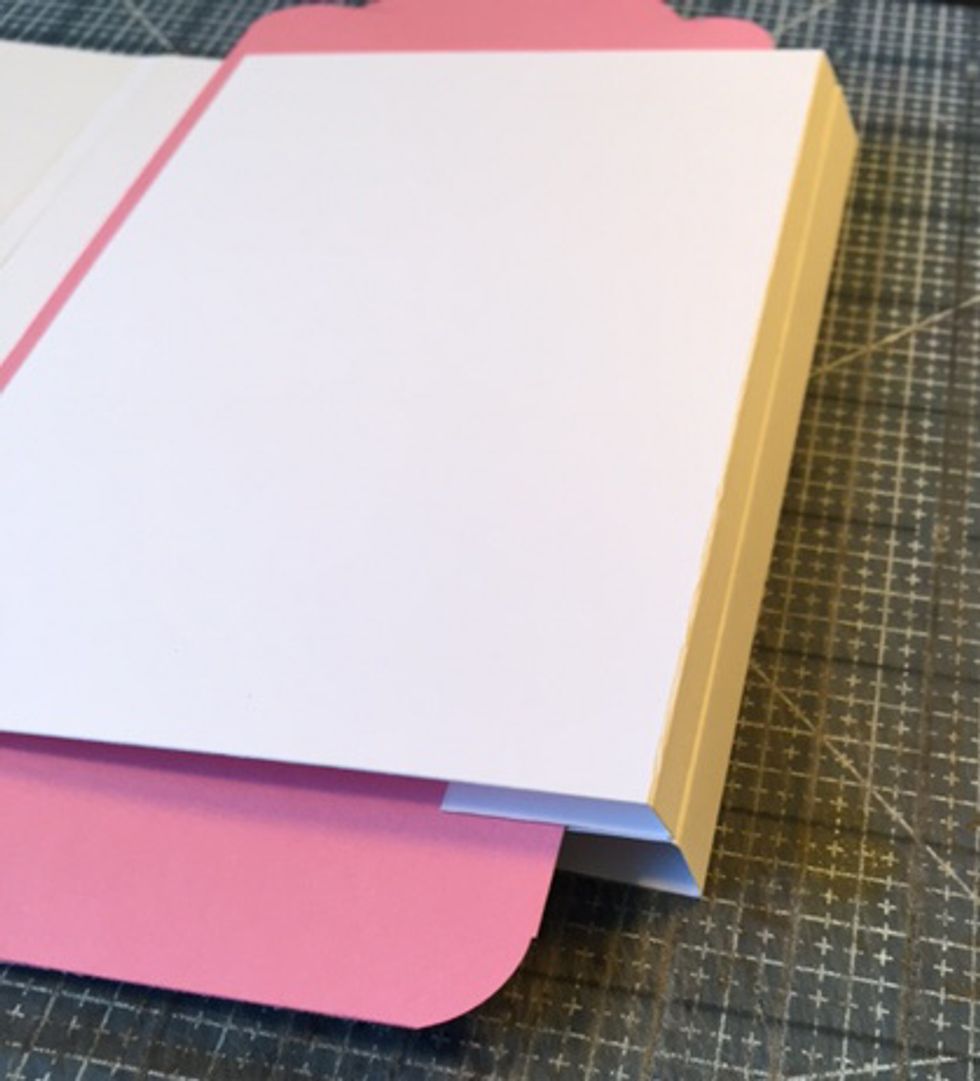 Sides of flaps will align to form sides of Tag-olio.