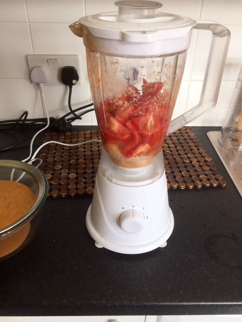 Sieve the mix into a bowl so get a smooth soup. Now you keep adding tomatoes, bread and water until you finish with the tomatoes. More bread=thicker if you want more of a soup consistency