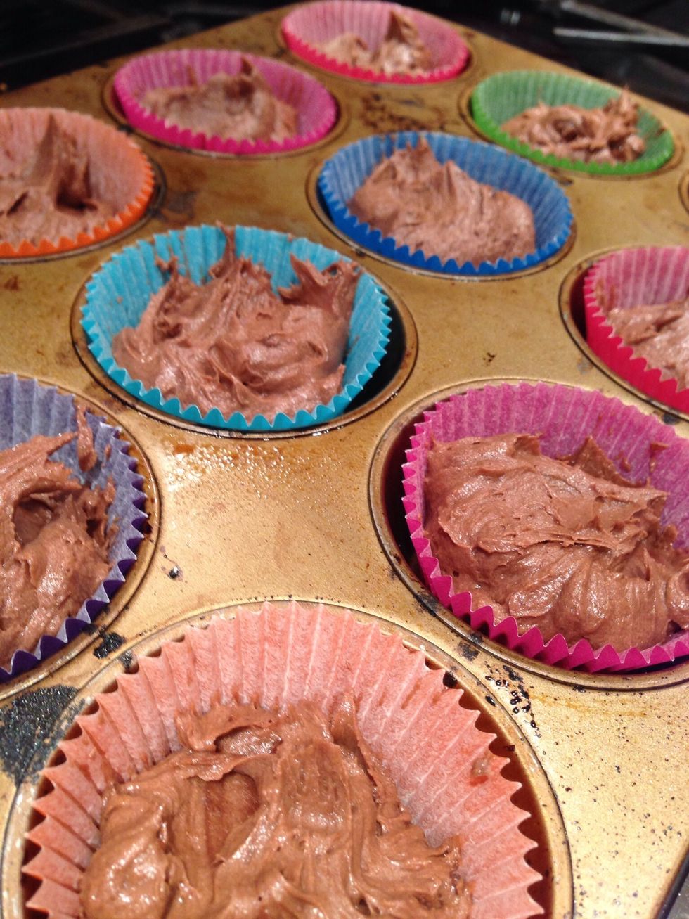 Sift 150grams flour and the cocoa into the mixture and fold in until smooth. Then fill 12 cases with the mix. Cook for 20mins at 180\u00b0C