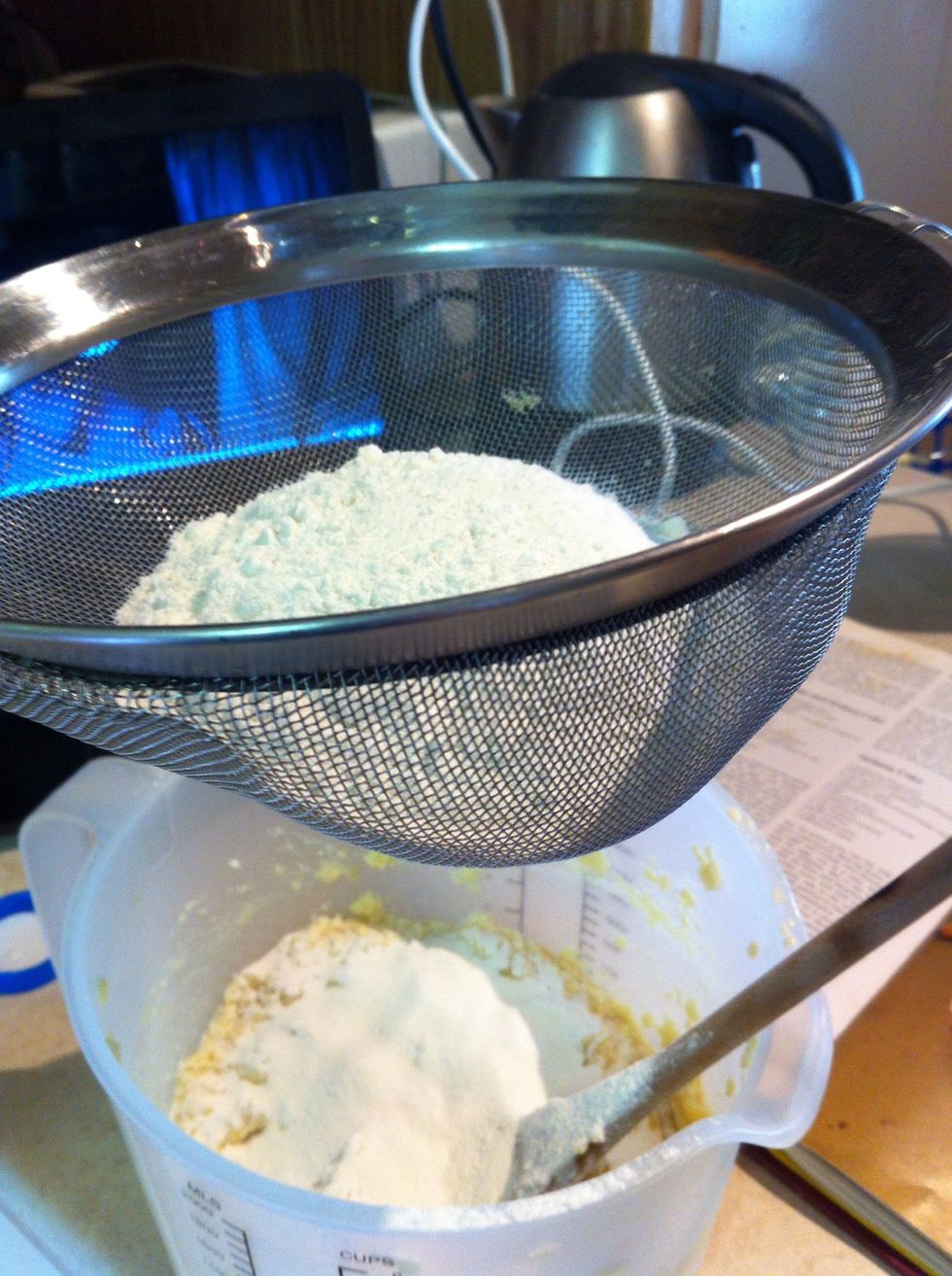 Sift in 1 cup of flour and mix until combined then sift second cup of flour and mix