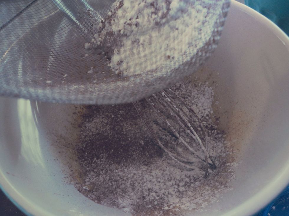 Sift in the flour, corn starch and cocoa powder. Make sure to get all of the lumps out.