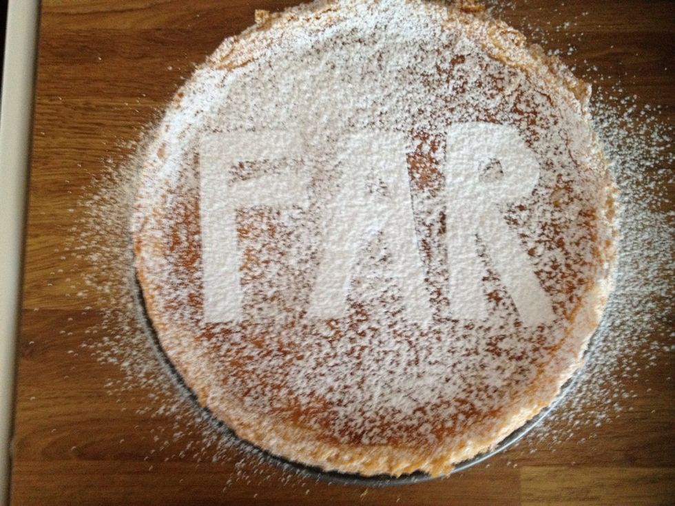 Sift powdered sugar on top of the cake. Make sure to cover it properly. Do this just before serving. If it's done in advance the sugar will melt into the cake and the text will disappear.