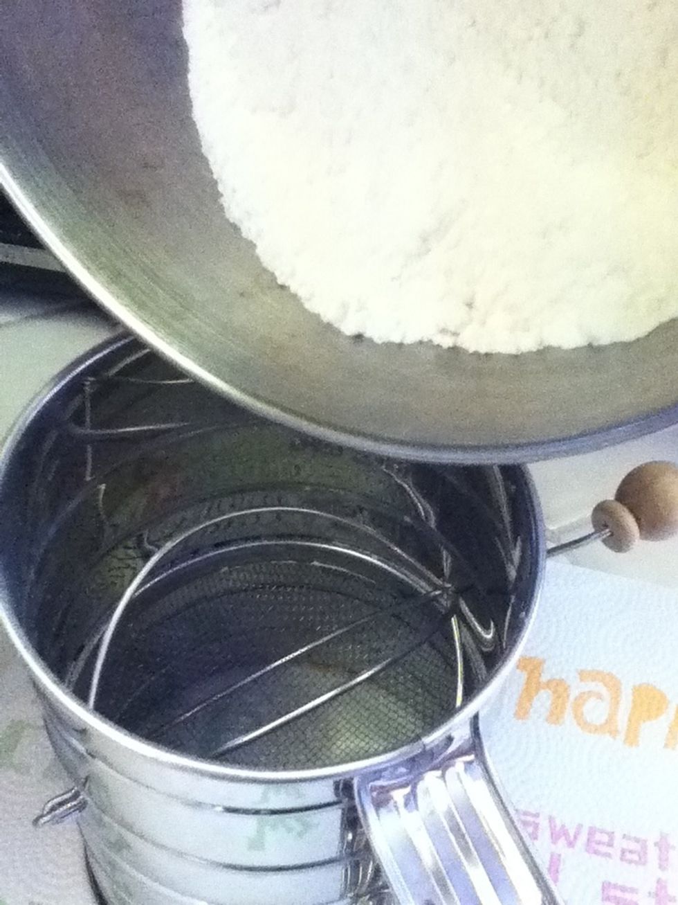 Sift the cake flour/sugar mixture, then add HALF of it to the egg whites. Beat slowly to blend.