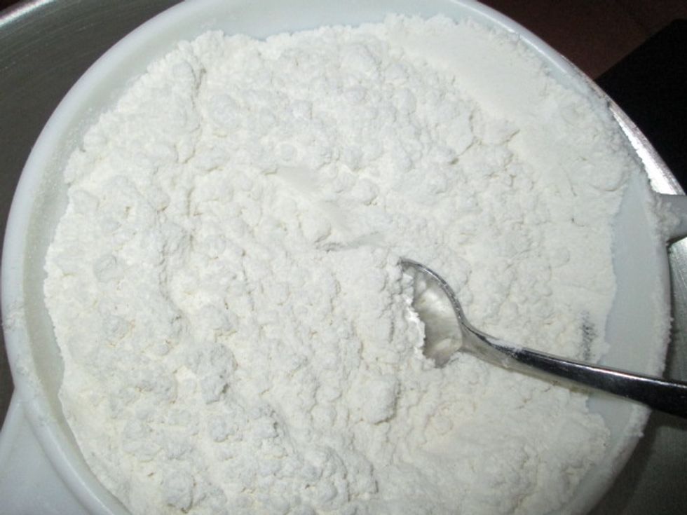 Sift the cake mix into the egg mixture.