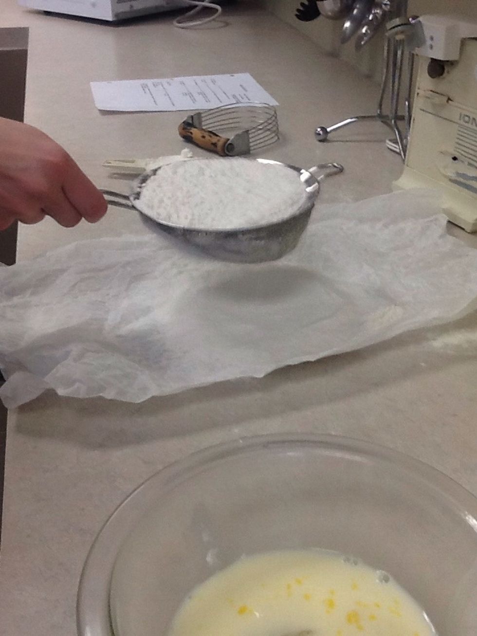 Sift the flour over wax paper