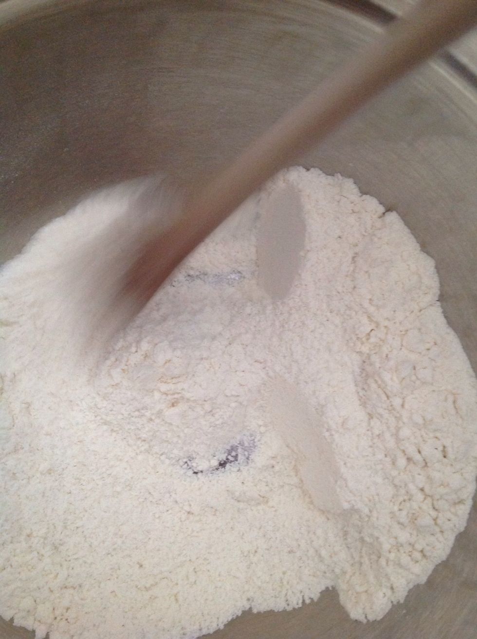 Sift the flours together in a medium bowl and add the coconut and stir, then make a well in the centre.