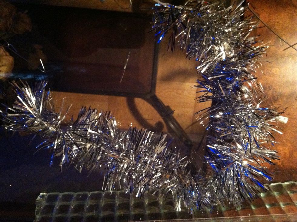 Silver fuzzy string ( to be honest I dnt know what it's called ) put it all around the tree