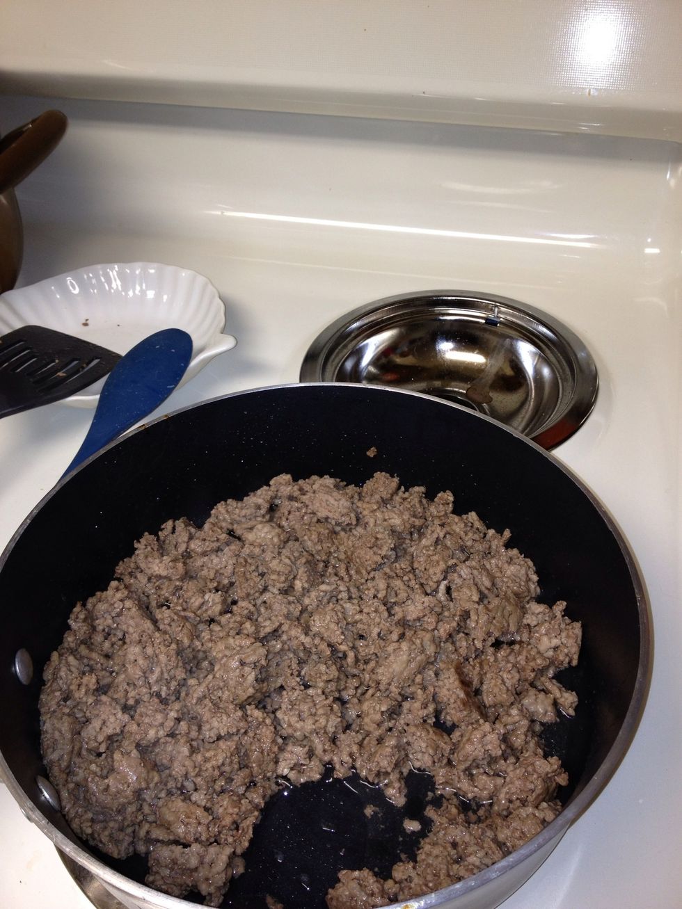 Simmer ground beef on medium heat until brown. Add a teaspoon of water to the pan before you start cooking to help separate the grease from the meat.