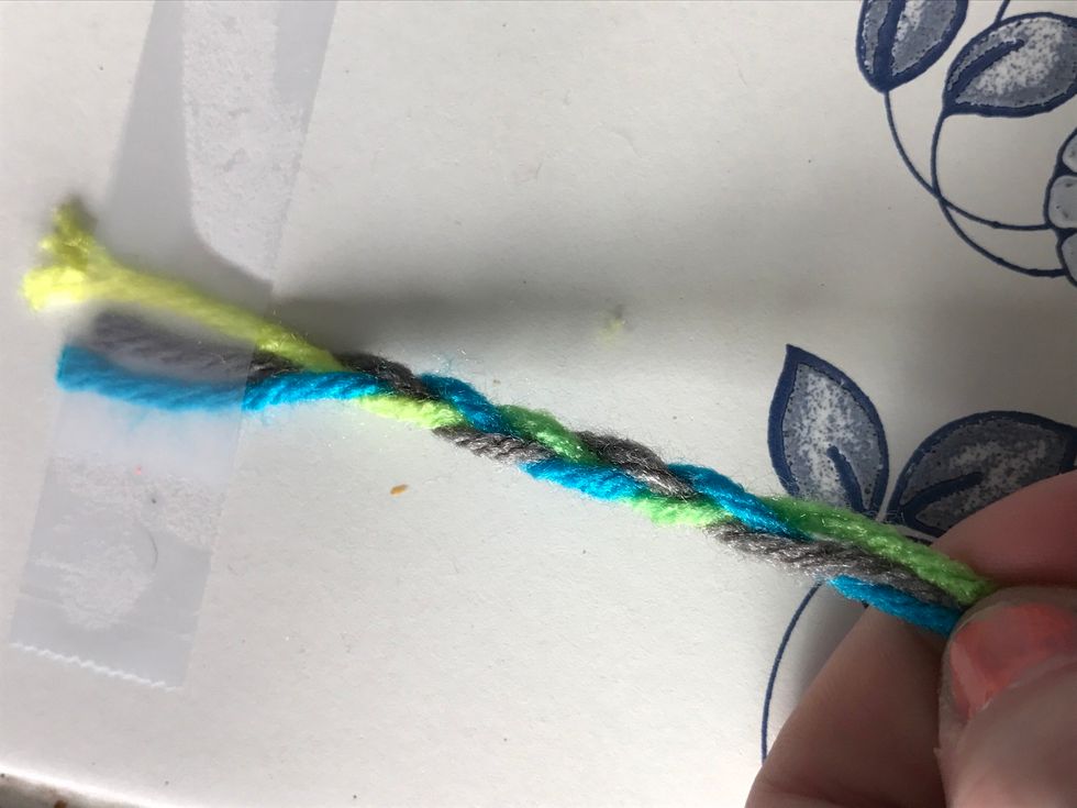 Simply braid the 3 strands of yarn. If you are not sure how to braid there's plenty of totorials on snap guide