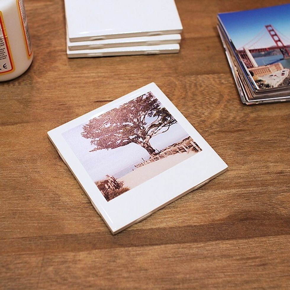 Simply eyeball an even amount of space from the top & the two sides, the bottom will be left with more white space to resemble a Polaroid. Smooth out the photo to remove any air bubbles & excess glue.