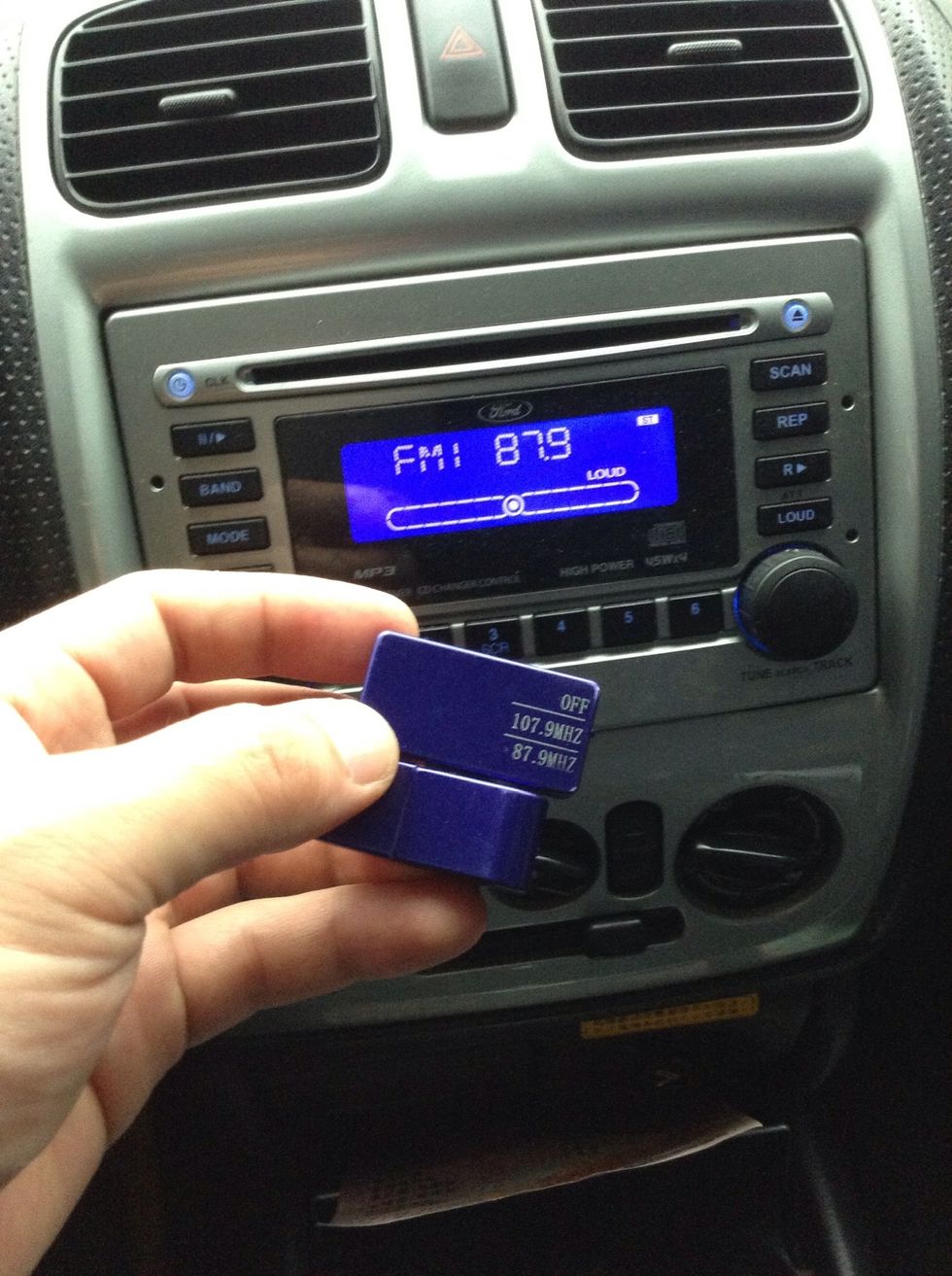 Simply set your car radio preset to 87.9FM