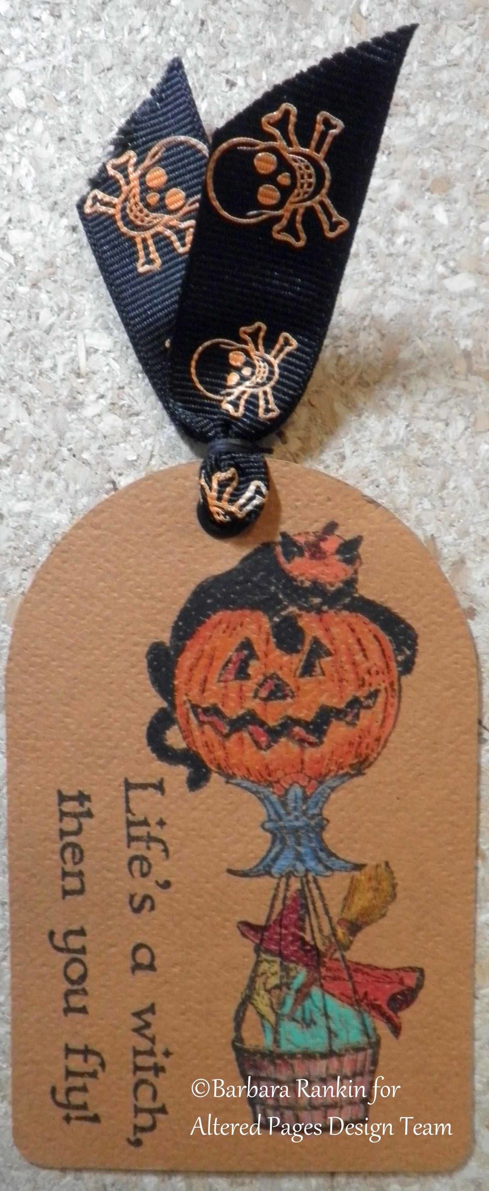 Sin City Stamps: Pumpkin balloon and Life's a witch, then you fly! stamped onto tag with black ink. Image colored with colored pencils. Skull ribbon colored with orange zest StazOn ink added to tag