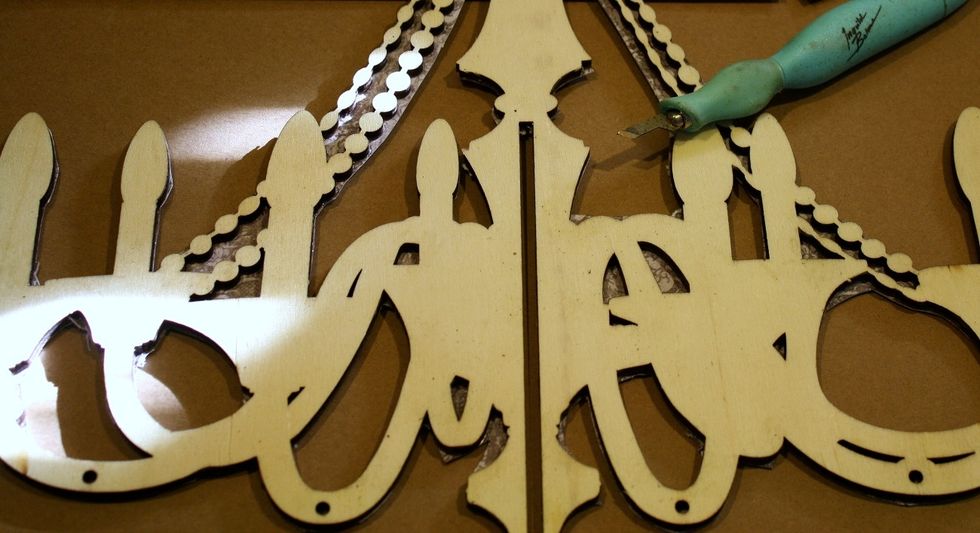 Since I am covering BOTH sides of my chandelier, I used my Prima craft knife to cut away even more excess paper just to have a cleaner work area. I will wet both sides at the same time.