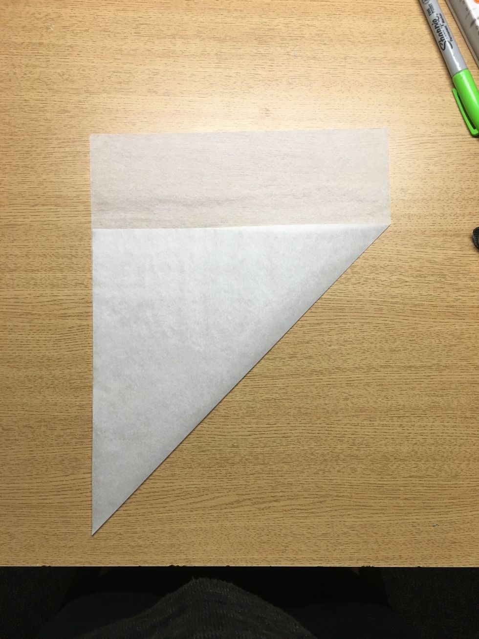 Since I like to have more round, circular snowflakes I usually cut the paper into a square first. I do this by aligning the bottom and left edge and creasing.