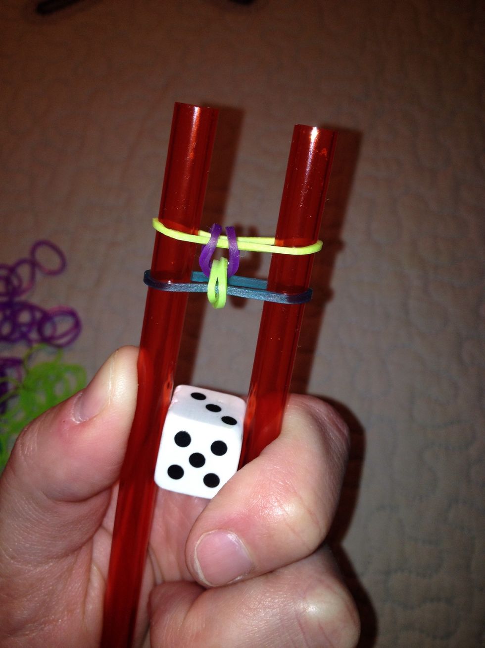 Since purple was at the bottom, it is the next to be looped over and nestled into the center.