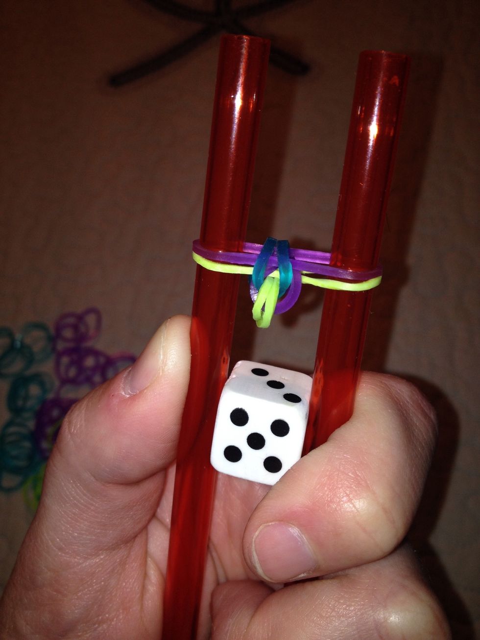 Since purple was last, a purple band was added and then the blue/teal was looped over the straws toward the center.