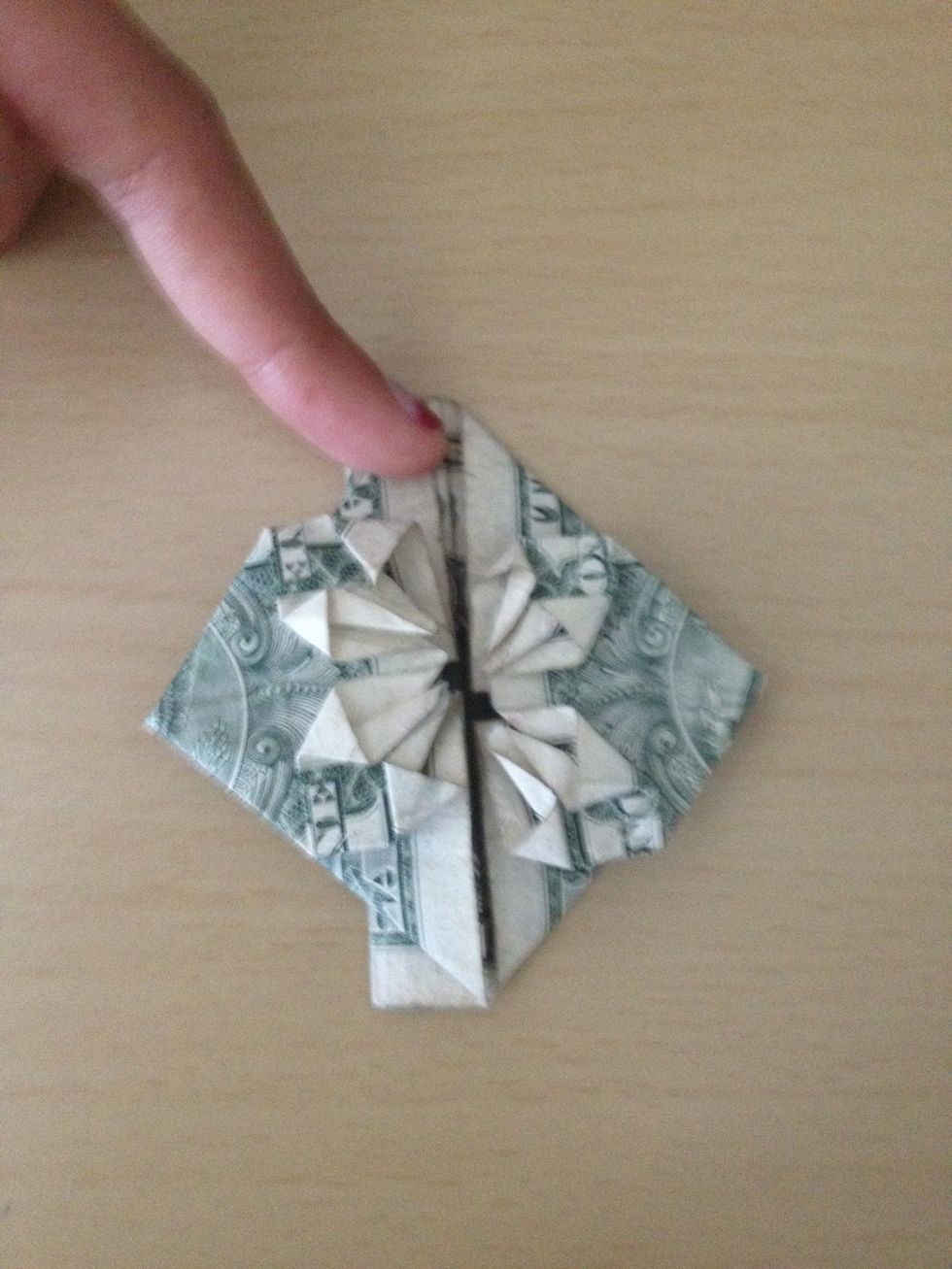 Since the fold in the beginning of the guide came undone, fold the dollar back over itself.