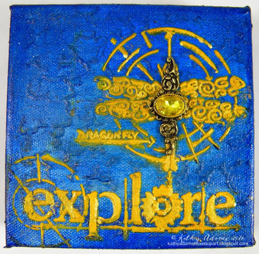 Since the gem that I found was clear, I colored it with a yellow Copic marker to match the canvas. The ink will stay in place because they are alcohol based markers.