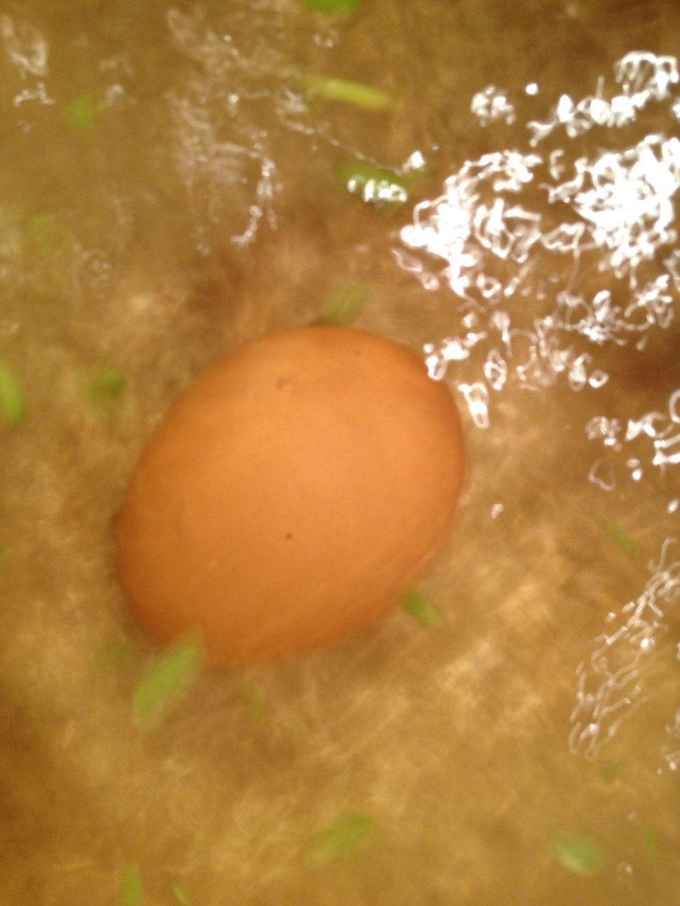Since the water is still boiling add a tempered egg to it. (meaning a egg that has been out of the fridge for a couple of minutes)