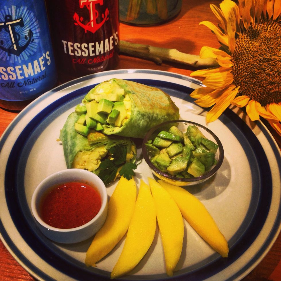 Since this is something I traditionally eat for breakfast I like to add some fresh fruit( I chose mangos this time) and I use the other tbsp of Tessemaes wing sauce to dip my wrap in! Enjoy!