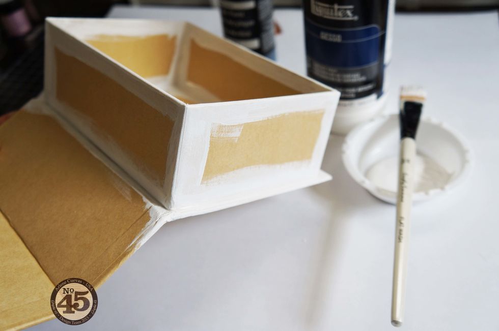 Since we will be covering the box with design paper, focus your efforts on the edges of the box. First, prime with Gesso using a paint brush.