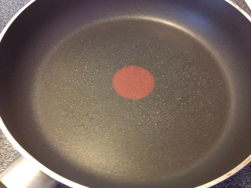 Since you already have shortening in the batter, simply spray the pan with cooking oil. You don't need to spray again.