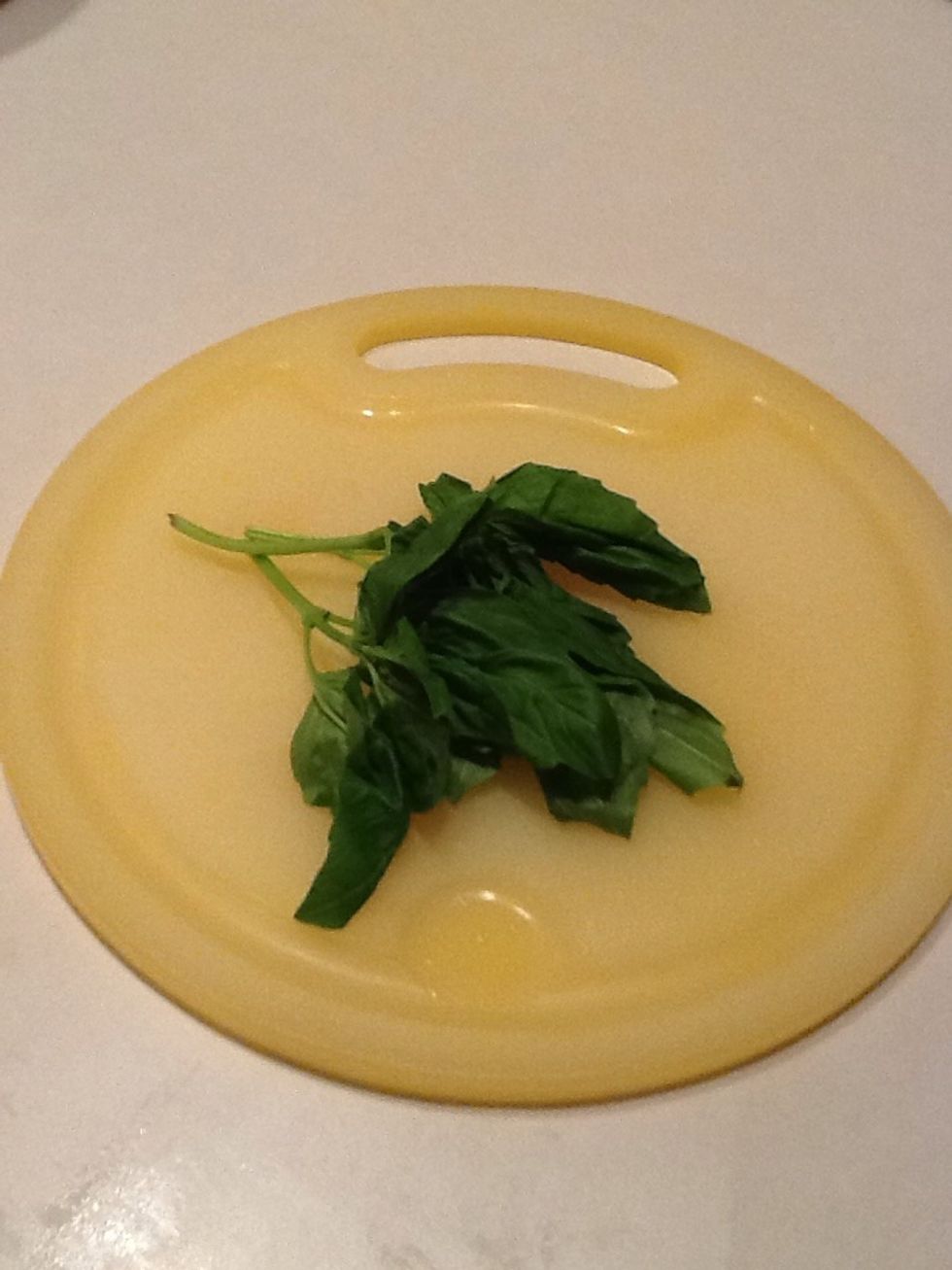 Since you are doing such a great job slicing and dicing, grab some basil leaves and chop them, too!