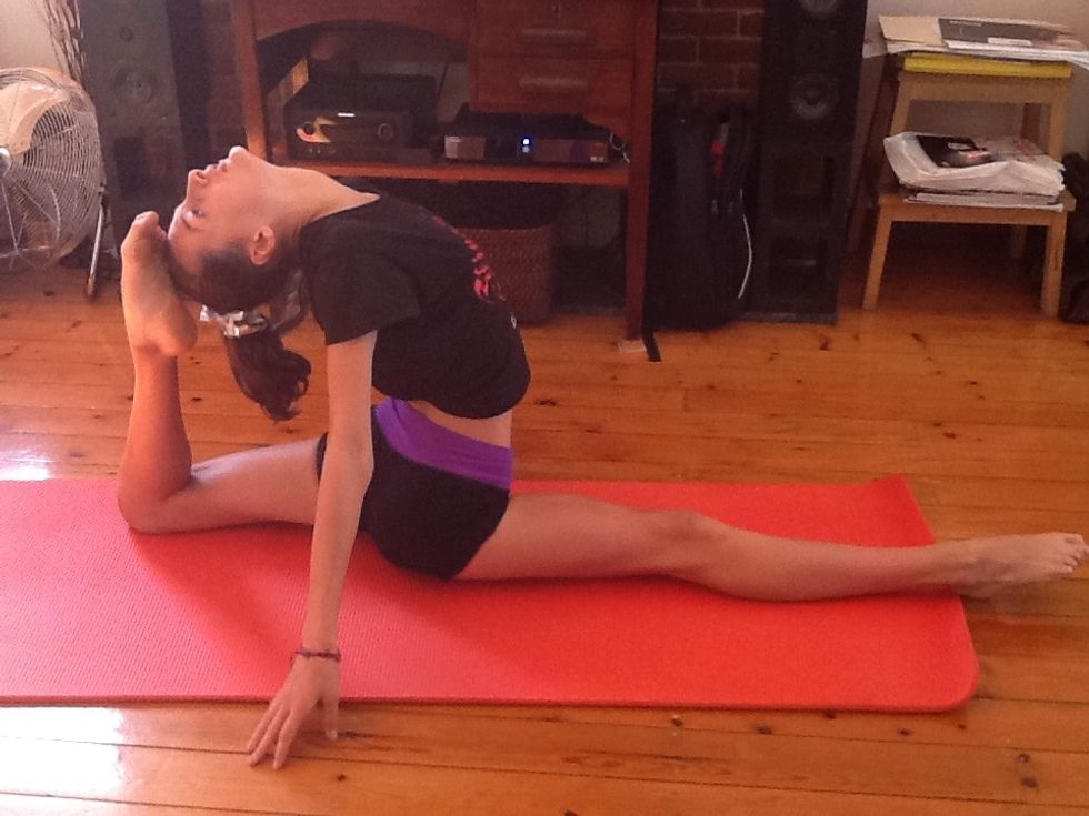 Sit in your splits then lift your back leg up as far as you can. You might not be able to get your foot to your head the first time.