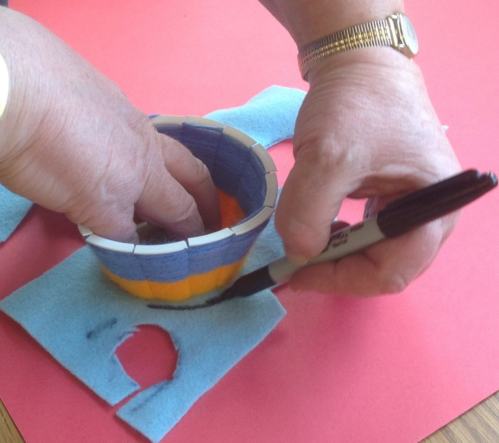 Sit the cup on the felt and trace around the base with permanent marker. PLEASE DO NOT CUT OUT OF THE CENTER - work from the edges first remember!