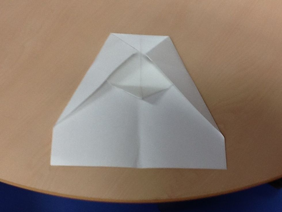 Sixth, fold both corners on the side to the half way point