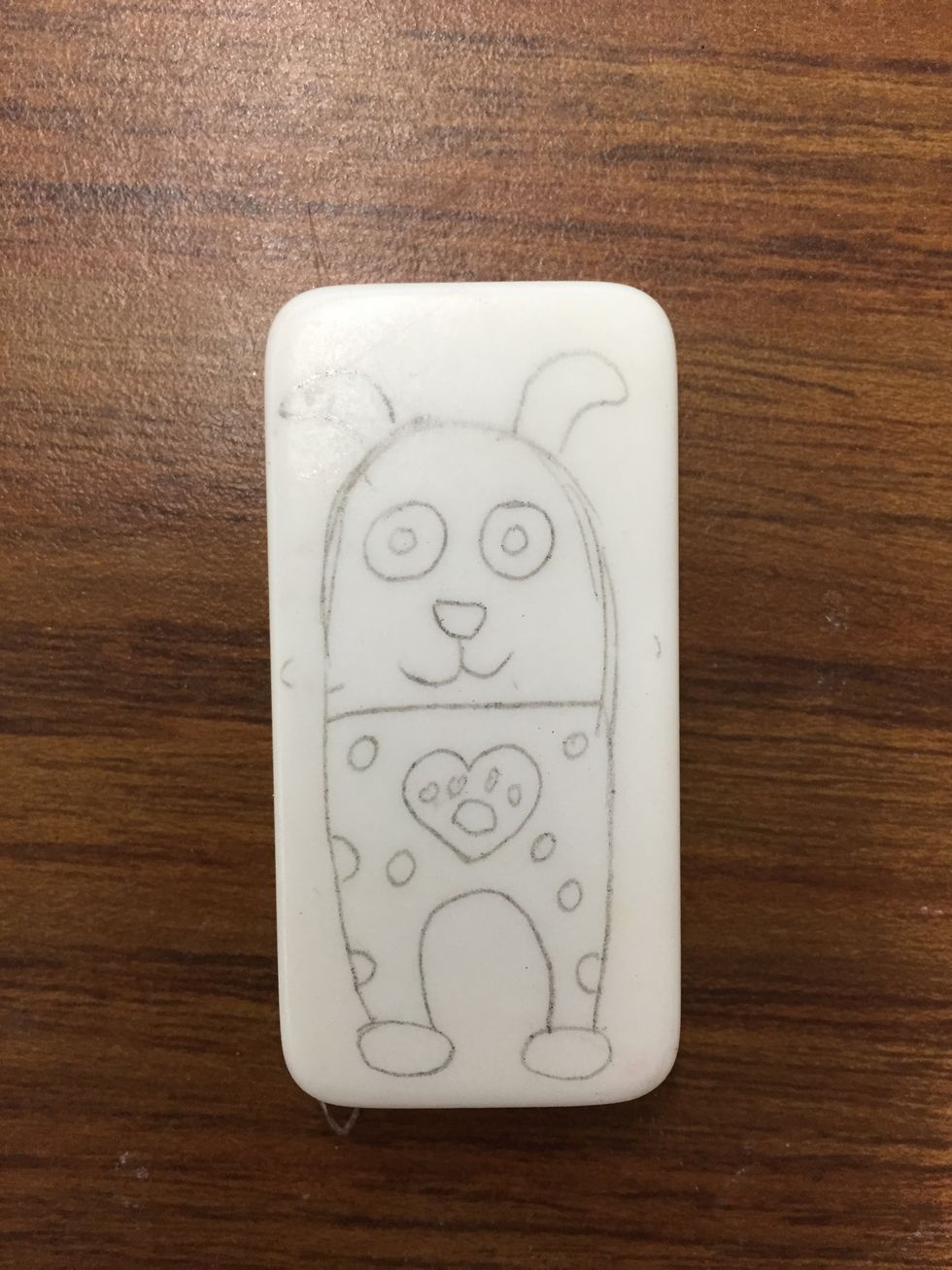 Sketch your design onto the domino with pencil