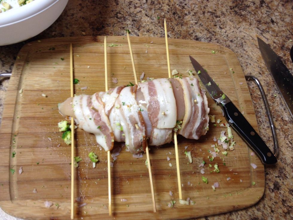 Skewer in between bacon.