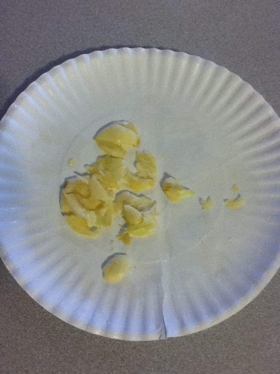 Skin some garlic and crush it by putting the cloves on a paper plate, then folding it in half over them and mashing down. Add this to the pot.