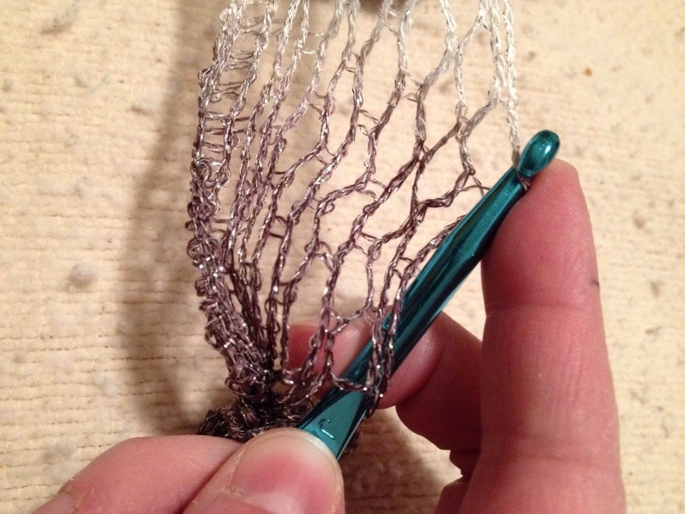 Skip a space and loop through the front to back to pick up a second stitch.
