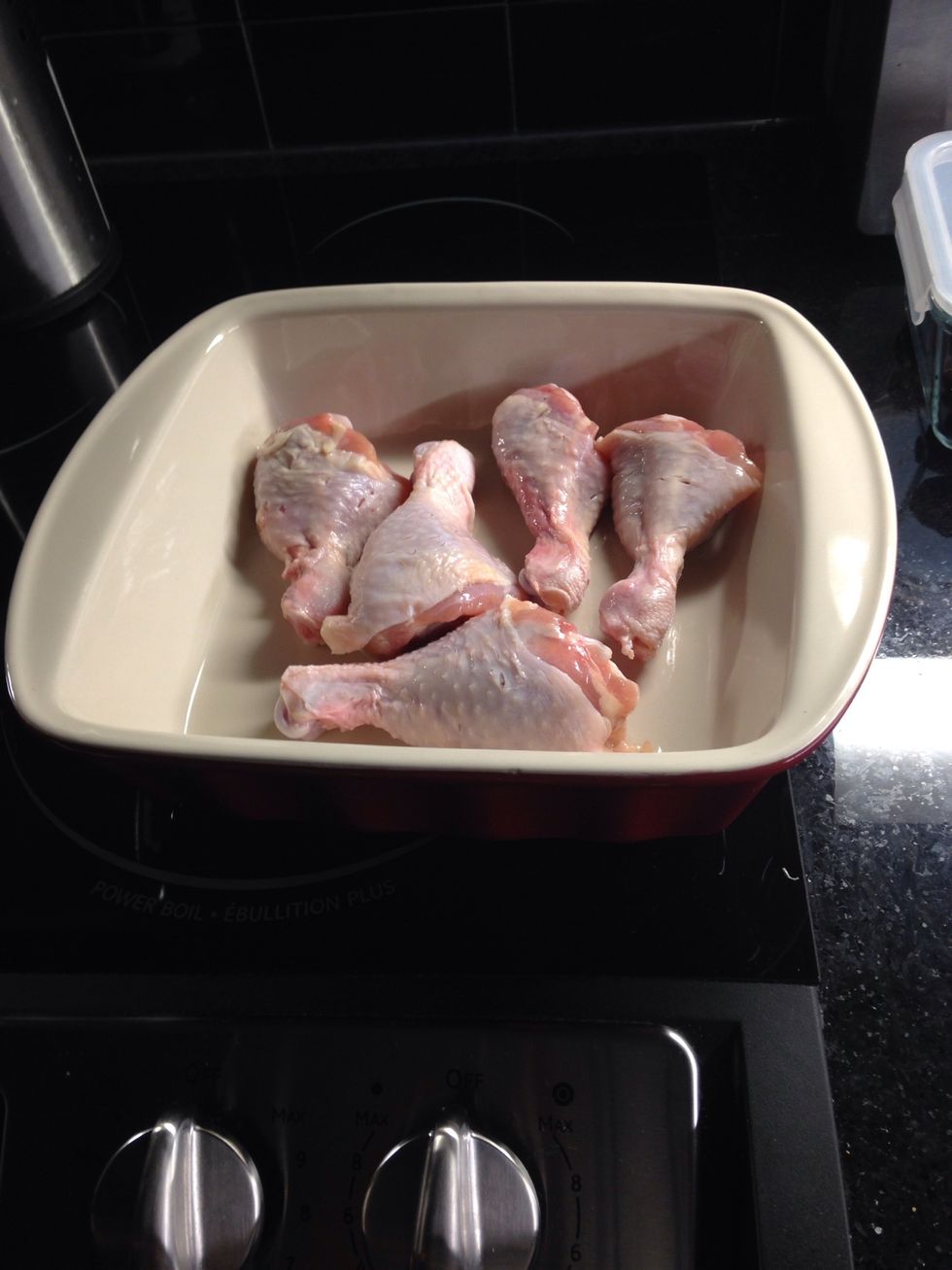 Slash drumsticks and place in baking dish.