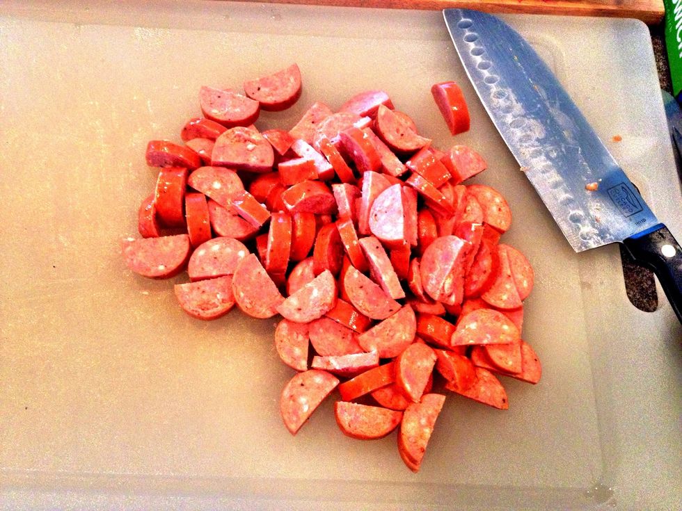 Slice 1.5-2lbs andouille lengthwise down the middle, then into roughly 1/4 inch pieces.
