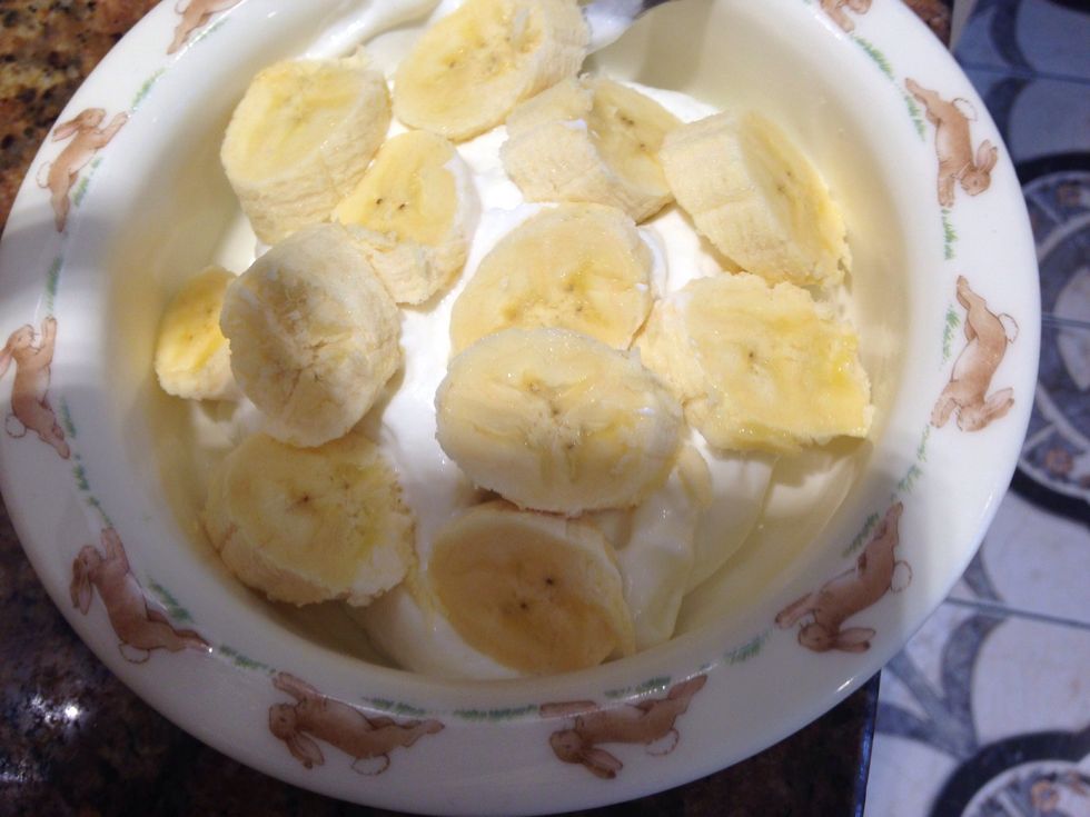 Slice a banana over the yogurt. Bunny bowl is completely necessary to optimal yumminess