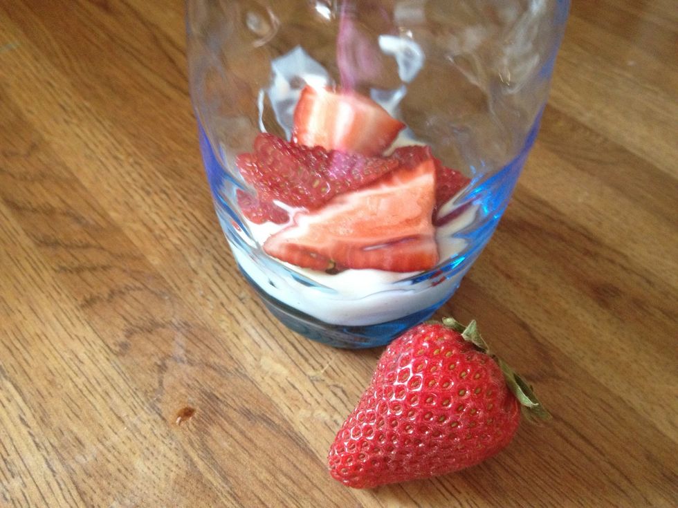 Slice a strawberry in to fourths and place in in your cup.