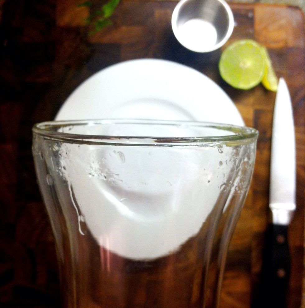 Slice a wedge of lime. Run it along the rim of the glass -- preferably chilled if you have time.