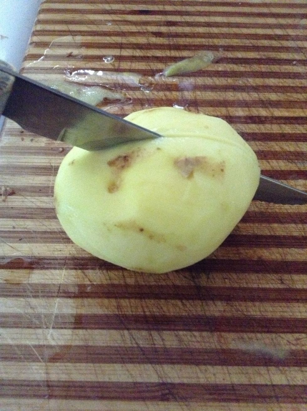 Slice all peeled potatoes in half