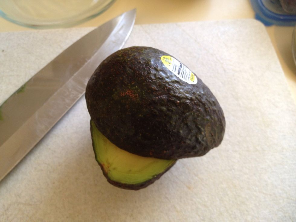 Slice all the way around avocados and twist.
