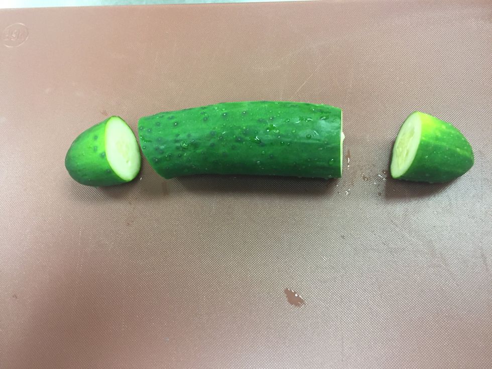 Slice an inch and a half to the edge of each side of the cucumber.