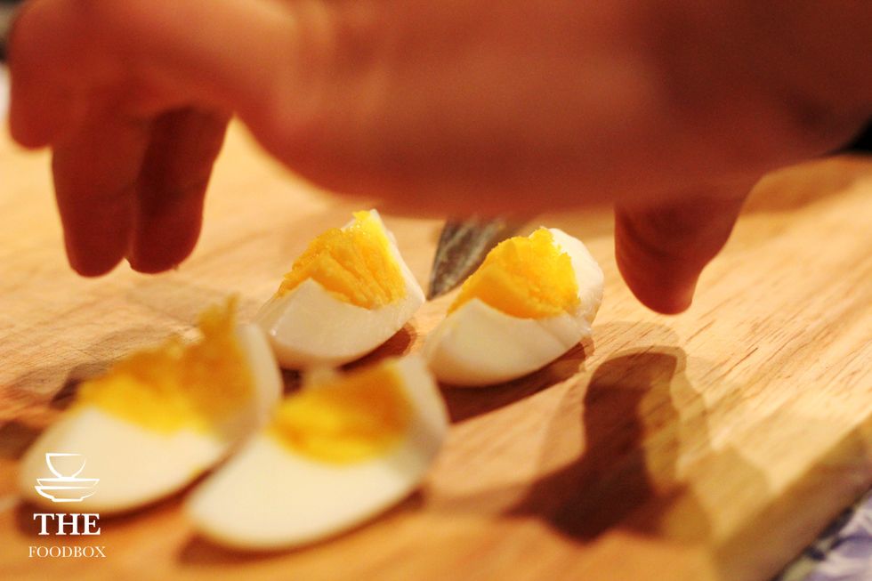 Slice and quarter your boiled eggs.