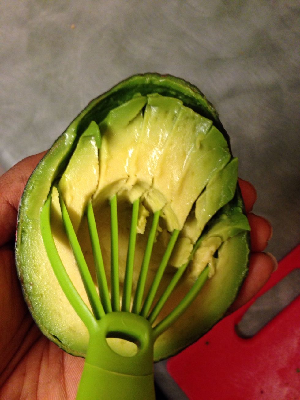 Slice and season the avocado. I LOVE this 2-in-1 slicer/masher I got from either target or Walmart. The masher is on the other end & looks like a flat flower.