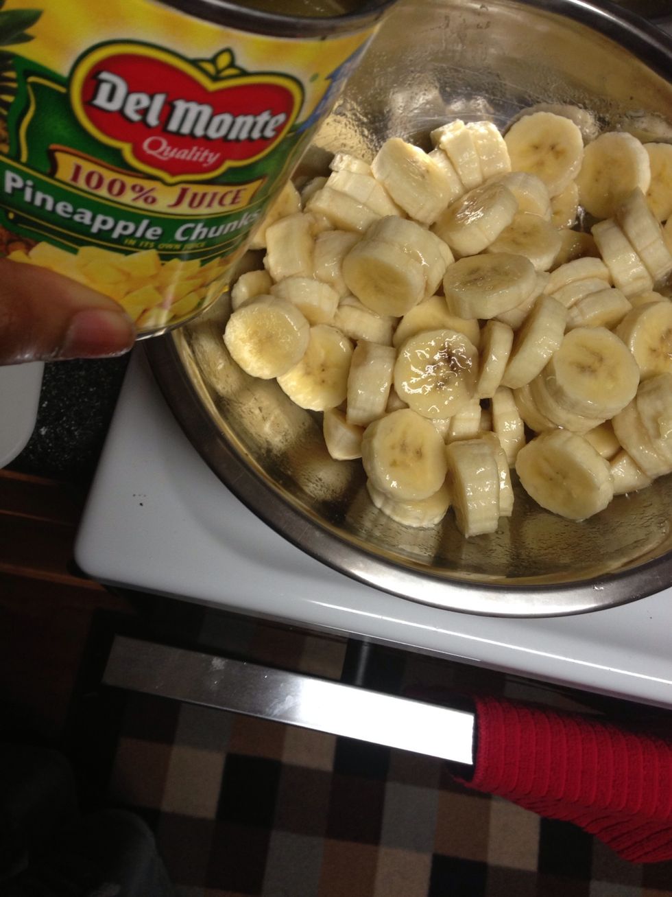 Slice bananas into a bowl & pour pineapple juice over them to keep them from turning brown. I didn't have plain juice, so I improvised! Lemon juice works too. Set bananas aside
