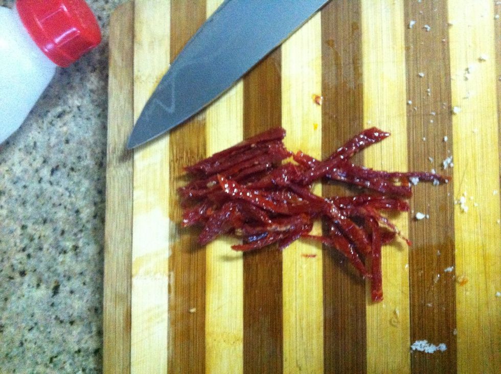Slice/chop up the sun dried tomatoes. Make sure they're soft tomatoes preserved in oil.