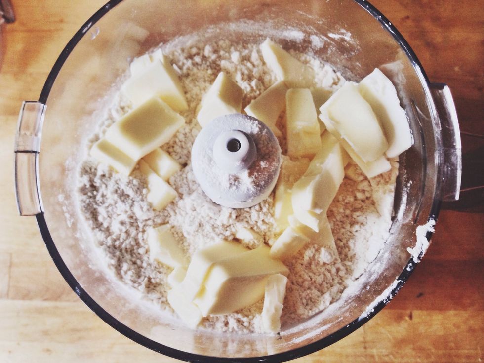 Slice COLD butter into cubes and add to the food processor. Pulse until butter is combined and some dough resembles "peas."