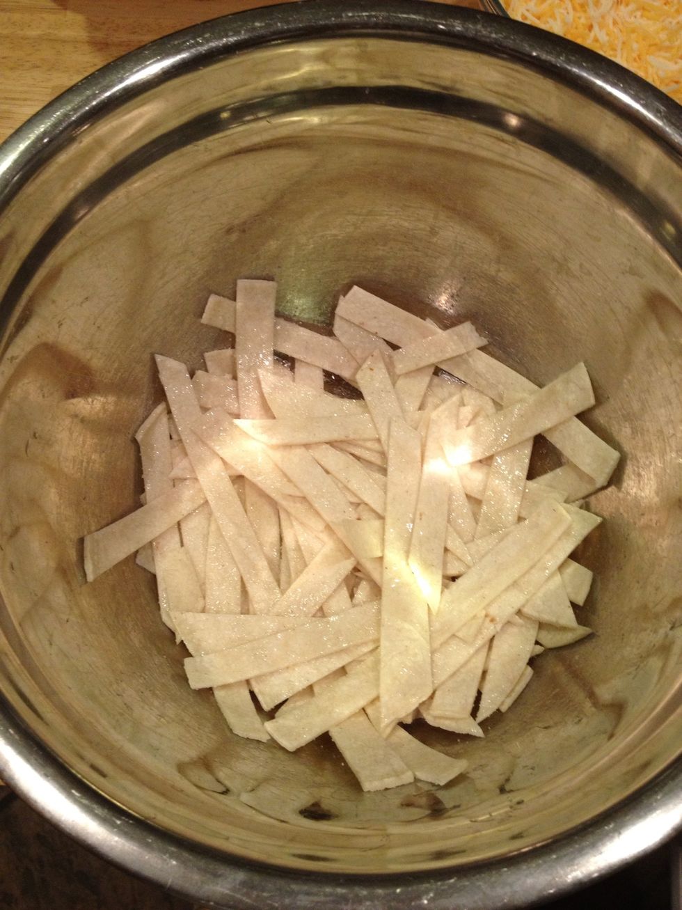 Slice corn tortillas into strips, and place in bowl. Drizzle olive oil to coat, salt and toss.