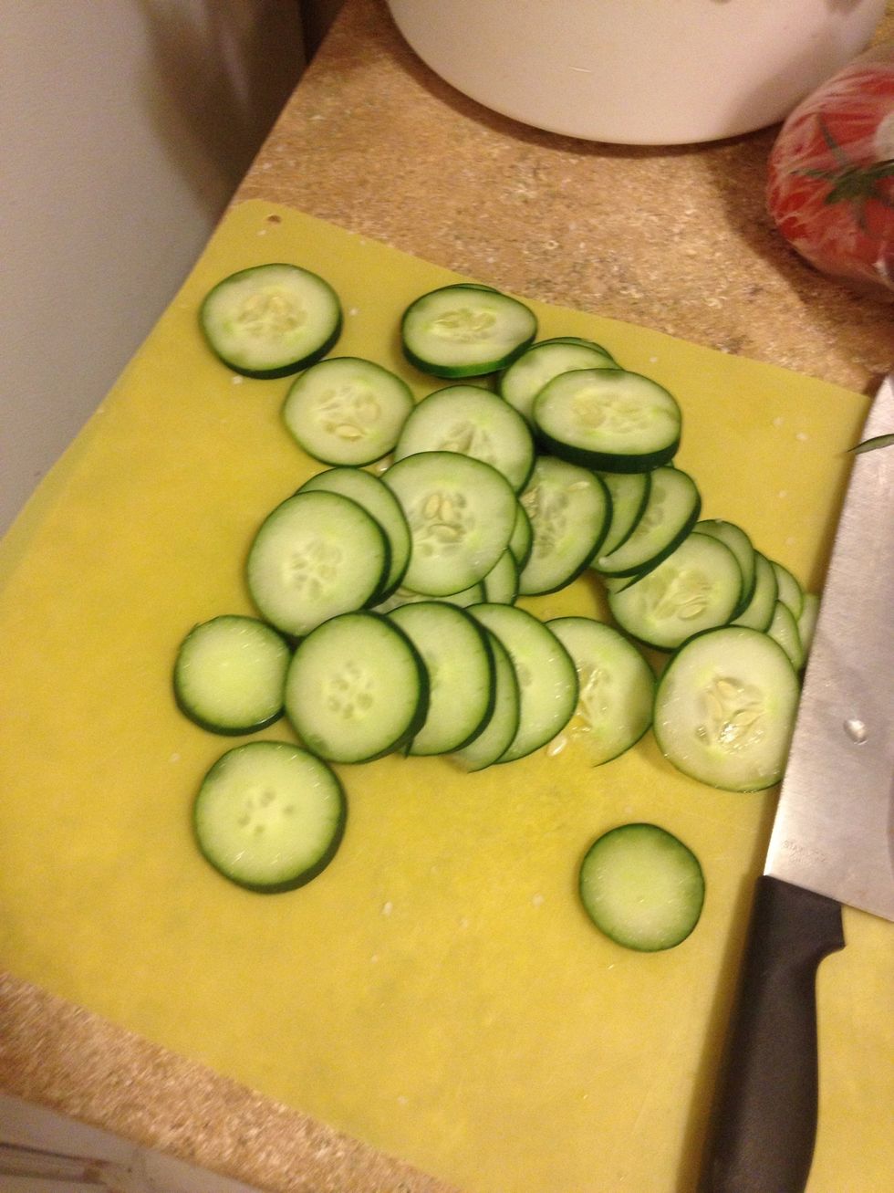 Slice cucumber, tomatoes, and mozzarella
