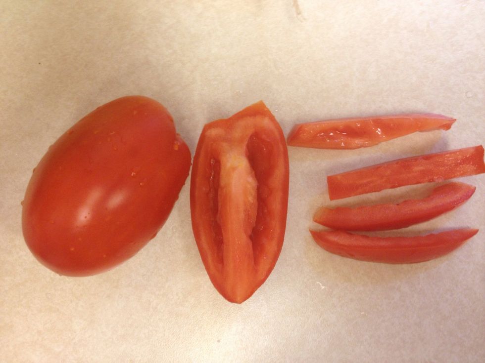 Slice each quarter of the tomato into three or four strips and them dice.